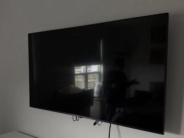 Large flat-screen TV wall mounted with hidden cables